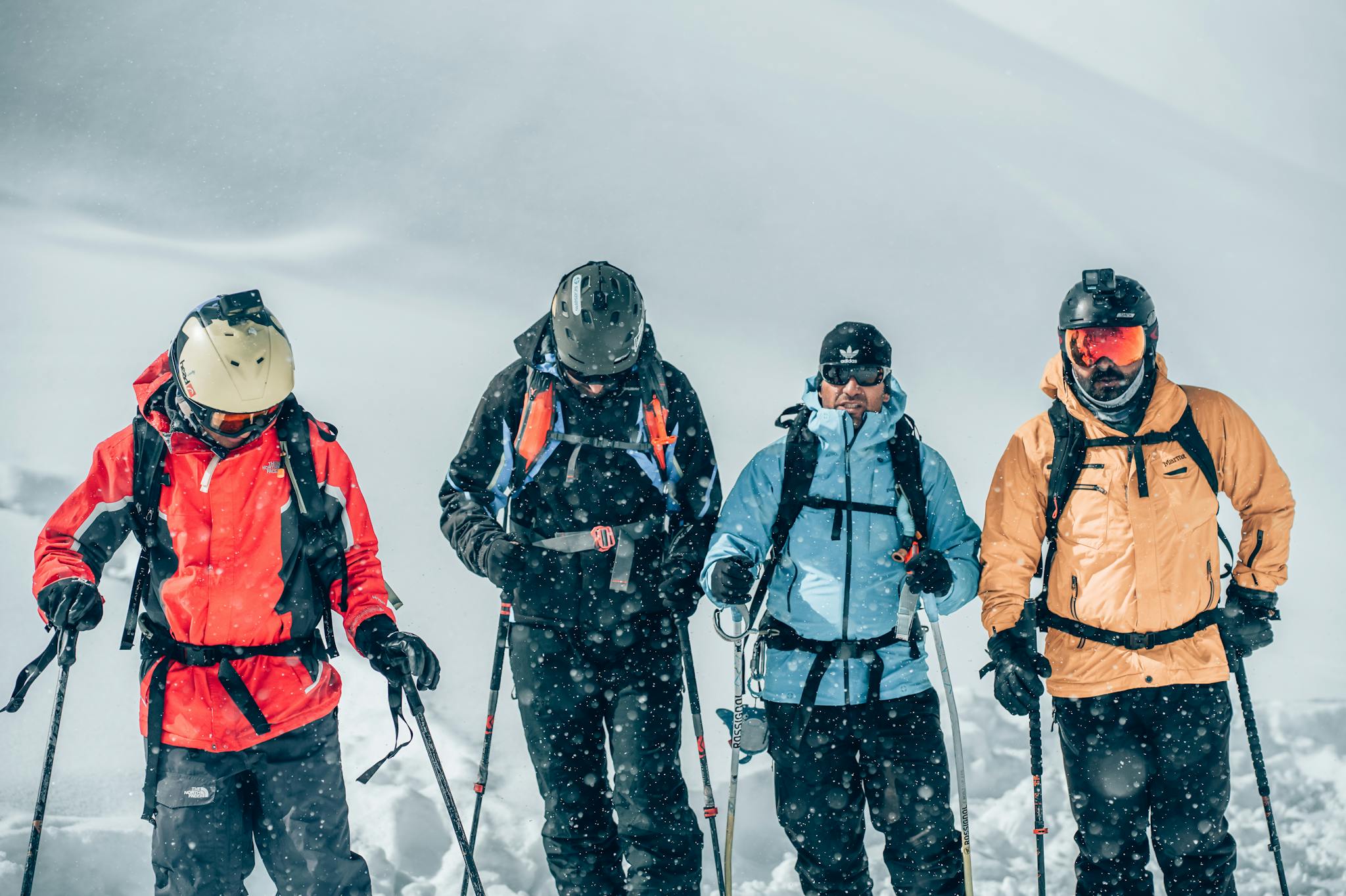 A group of well-equipped skiers navigating snowy terrain during a winter adventure, showcasing vibrant gear and energy.