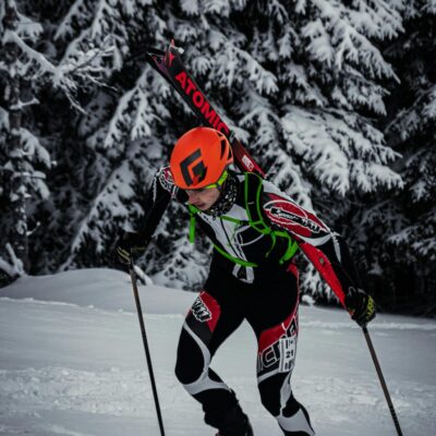 A skier climbs up a snowy slope in Mozirje, Slovenia, during winter activities.